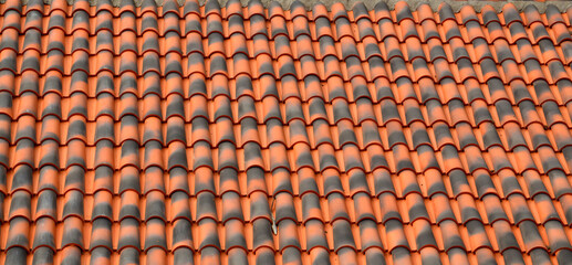 Fototapeta premium Red brown ceramic tile texture background.Roof of a house with modern shingles.Selective focus.