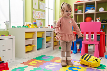 Adorable blonde girl smiling confident standing at kindergarten
