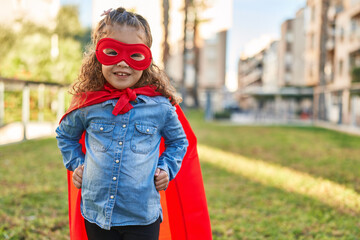 Adorable blonde toddler smiling confident wearing superhero custom at park © Krakenimages.com