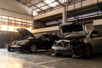 car in automobile repair service center with soft-focus and over light in the background - obrazy, fototapety, plakaty