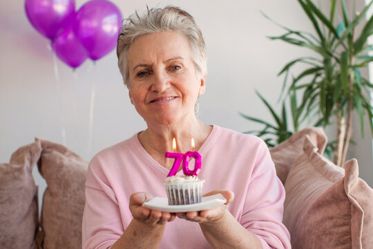 Elderly Smiling Cool Happy Woman 70s Hold Birthday Cake With Candle