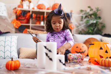 Fototapeta premium Adorable hispanic toddler having halloween party standing at home