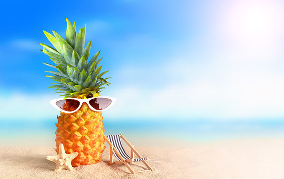 Pineapple with sunglasses on tropical beach background. Summer beach concept.