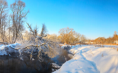 Fototapeta na wymiar Winter landscape with snow covered trees and forest river