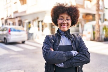 African american woman smiling confident standing with arms crossed gesture at street