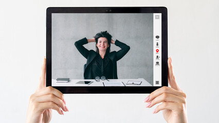 Online success. Video conference. Virtual interview. Satisfied relaxed happy business woman in digital office on tablet screen in hands isolated on white.