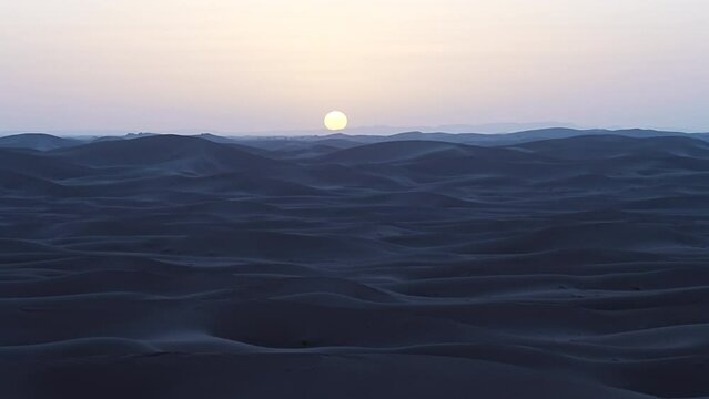 Sun set over Erg Chigaga dune in Sahara desert in african southeastern MOROCCO, clear blue sky in 2023 warm sunny winter day on January.