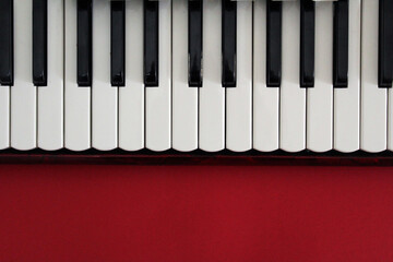 Piano keyboard on a red background