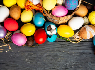 Fototapeta na wymiar Happy Easter banner, background, card. colored Easter eggs and regular egg on wooden holiday selective focus image. 