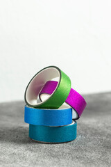 Multicolored rolls of decorative tape.