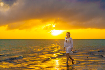 Fototapeta premium Beach holiday - woman walking on sunny, tropical beach