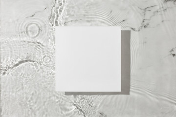 Sunlight scene with square podium for presentation on the water surface marble background. Flat lay cosmetic spa mockup.