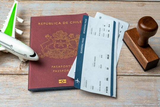 Chile passport, stamp, plane and boarding pass on a map of the world. Business trip. Holidays and adventure. Documents required for travel