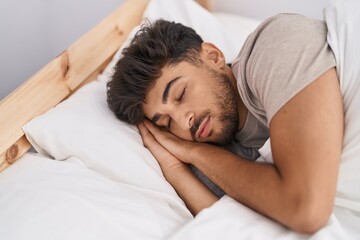 Fototapeta na wymiar Young arab man lying on bed sleeping at bedroom