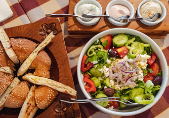 Greek Village Salad, bread and dips in restaurant in Cyprus island country