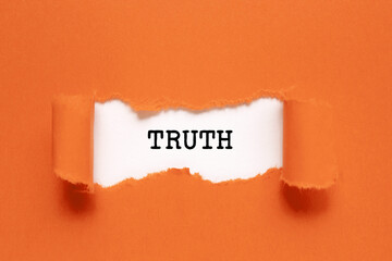 The word Truth appearing behind torn orange paper.