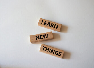 Learn new things symbol. Concept words Learn new things on wooden blocks. Beautiful white background. Business and Learn new things concept. Copy space.
