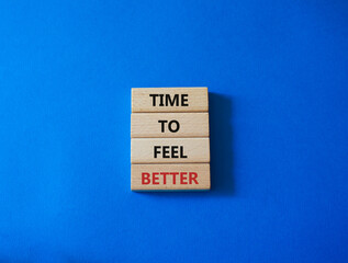 Time to feel better symbol. Wooden blocks with words Time to feel better. Beautiful blue background. Medicine and Time to feel better concept. Copy space.