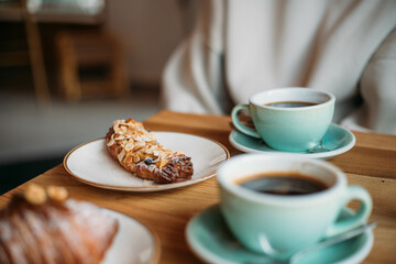 a sweet pastry, a croissant and a mug of coffee
