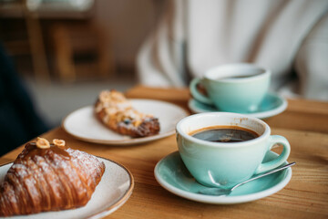 a sweet pastry, a croissant and a mug of coffee