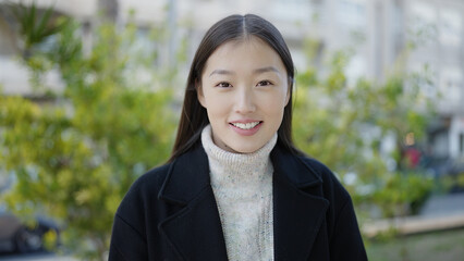 Young chinese woman smiling confident standing at park