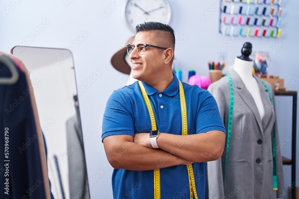 Sticker young latin man tailor smiling confident standing with arms crossed gesture at atelier