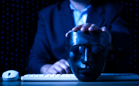 Hacking and malware concept, Hacker using abstract laptop with binary code digital interface, man holding a black mask.