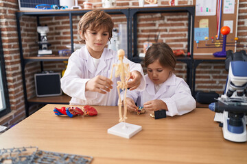 Brother and sister students having anatomy lesson at laboratory classroom