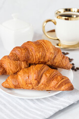 Morning with a cup of coffee and croissants. On a white background. Breakfast.