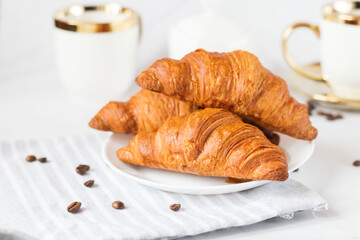 Morning with a cup of coffee and croissants. On a white background. Breakfast.