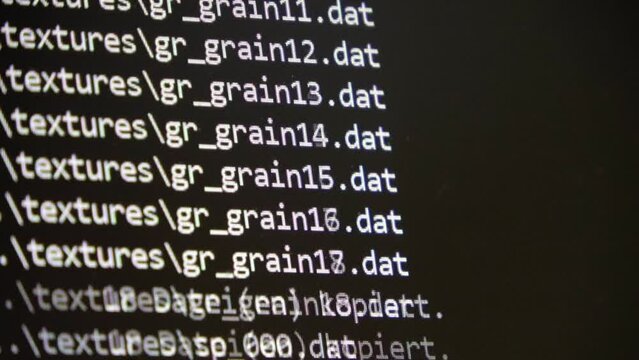 Computer Source Code scrolls on a screen.