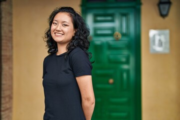 Young chinese woman smiling confident standing at street