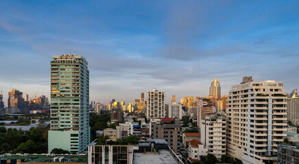 Fototapeta na wymiar Sunrise over the houses and skyscrapers of Bangkok, Sukhumvit, Thailand.