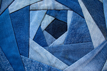Jeans background, patchwork texture. The new life of old jeans. Recycling old clothes. Denim quilt for a pillow in the crazy-rose technique - obrazy, fototapety, plakaty