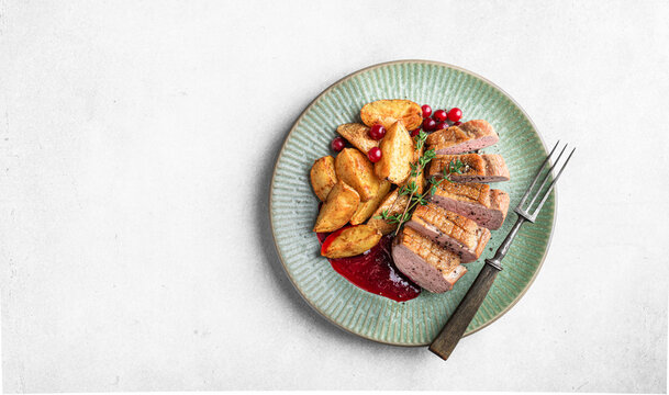 Duck breast steak with potatoes and berry sauce