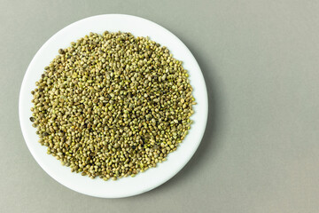 A pile of organic dried hemp seeds on a plate