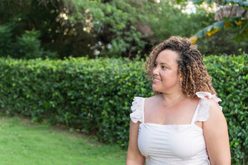 Latin woman with curly hair in the park