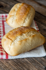 Two tender breads on a napkin and wooden background.