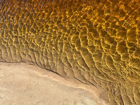 River orange yellow water containing  iron compounds.
