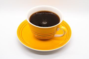 Yellow striped coffee cup and saucer isolated on a white background