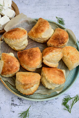 Fresh baked home made  Mini cheese puff pastries and cream  spread cheese.Cheese pie with phyllo pastry and herbs