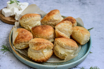 Fresh baked home made  Mini cheese puff pastries and cream  spread cheese.Cheese pie with phyllo pastry and herbs