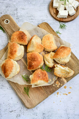 Fresh baked home made  Mini cheese puff pastries and cream  spread cheese.Cheese pie with phyllo pastry and herbs
