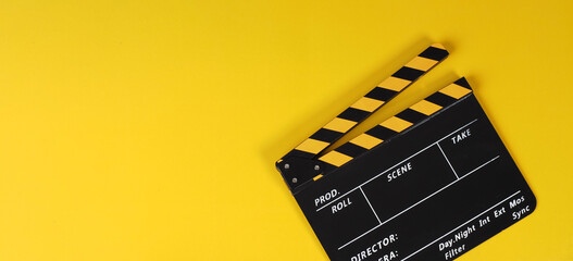 Clapper board or yellow movie slate on yellow background.. - obrazy, fototapety, plakaty