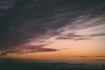 Naklejka premium Sunset with moody brown skies