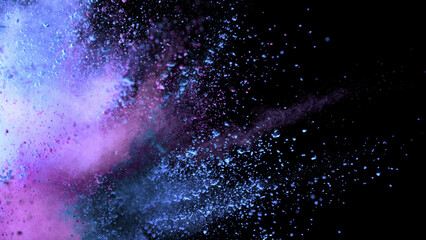 Colored powder explosion. Abstract closeup dust on backdrop.