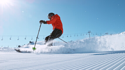 Alpine skier running down the hill. - obrazy, fototapety, plakaty