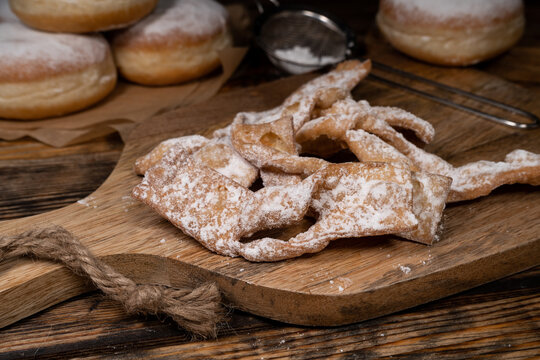 Angel wings, traditional deep-fried dough, sprinkled with powdered sugar. Sweet crisp pastry in shape of twisted ribbons. Popular in Poland during Carnival and Fat Thursday Tłusty czwartek feast day.