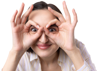 Close up portrait of attractive quirky young woman making binoculars with hands showing ok gesture on white studio background.