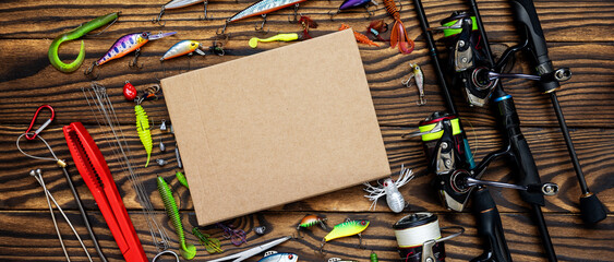 Fishing tackle on a wooden background. Fisherman Gear for catching Fish. Panoramic banner.